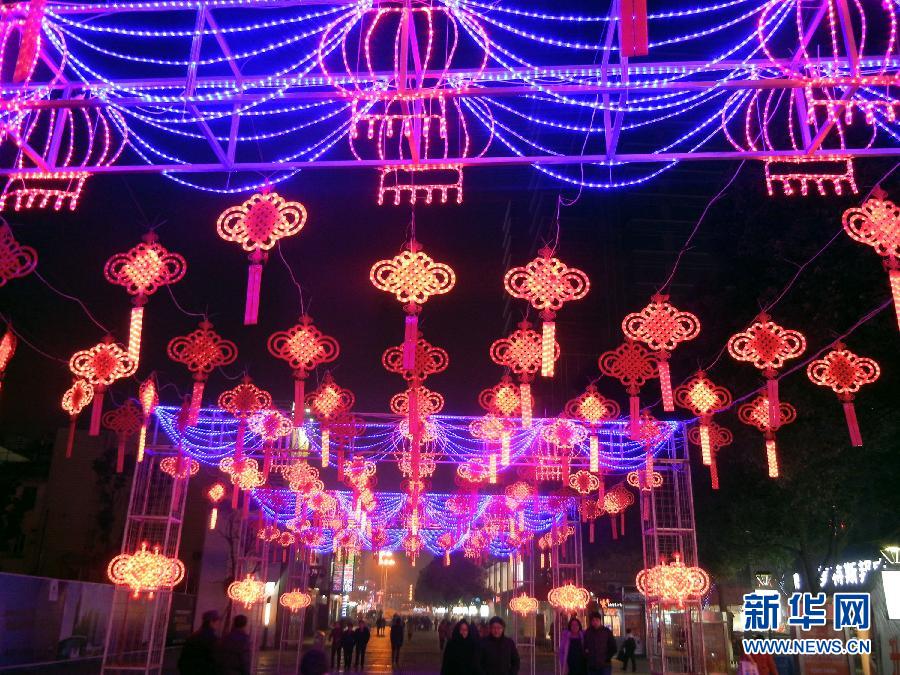 　1月30日，市民走在由中國(guó)結(jié)霓虹燈裝扮的蘇州街頭。