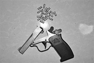 警方從搶劫嫌疑人處起獲的贓款和發(fā)令槍、子彈。警方供圖