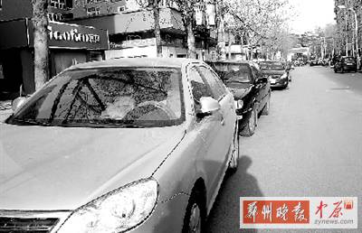 友愛(ài)路，路邊停了一排車(chē)，本來(lái)不寬的路就變得更窄了。