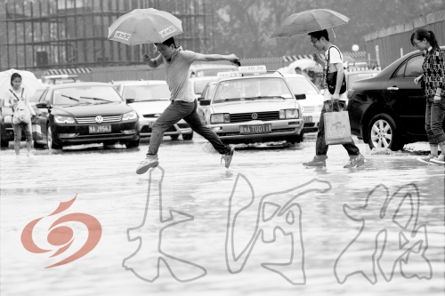 鄭州經(jīng)三路與北環(huán)交叉口處，積水較深，行人們不得不“練輕功”。 記者 白周峰 攝影