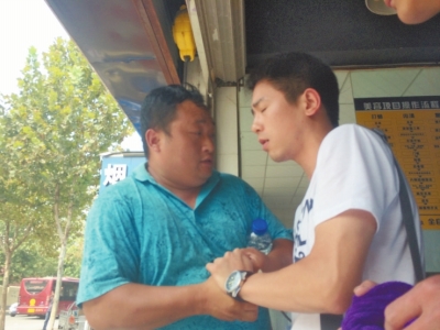 記者正查看照片，突遭藍(lán)衣男強(qiáng)搶手機(jī)。