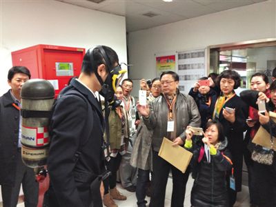 昨天，地鐵4號線北京南站站，地鐵工作人員為人大代表演示應(yīng)急氧氣瓶佩戴方式。新京報記者