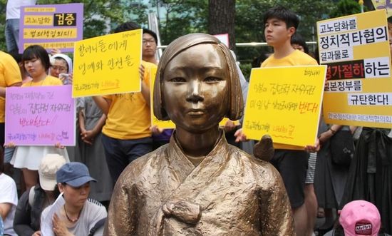 7月2日，在韓國首爾的日本駐韓國大使館前，民眾在慰安婦少女像旁手持標語參加抗議活動。