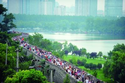　　昨天,數(shù)萬南京市民參加“環(huán)城七十里”徒步走,圖為解放門城墻上密集的人群。 本版攝影 實(shí)習(xí)生 王甜